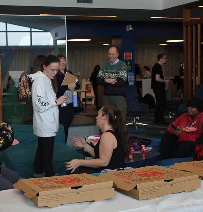 President Vander Hooven and students in the Student Center.